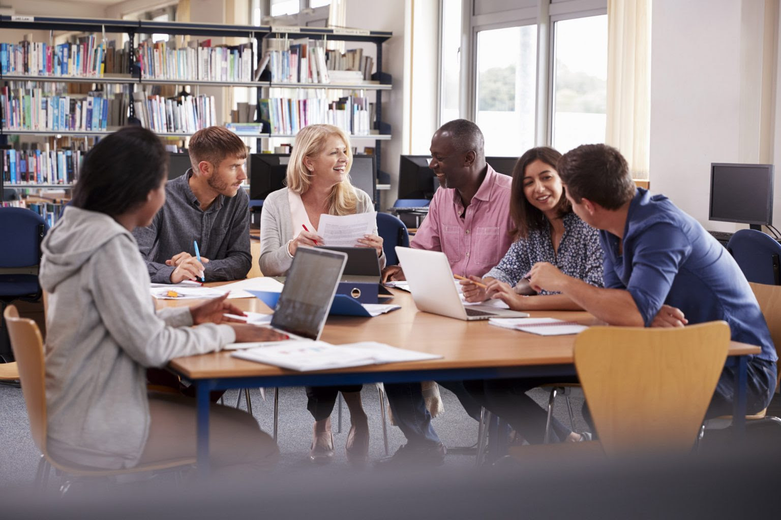 Student and teachers sitting at a table